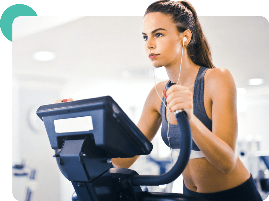 A woman is using an exercise bike in the gym.