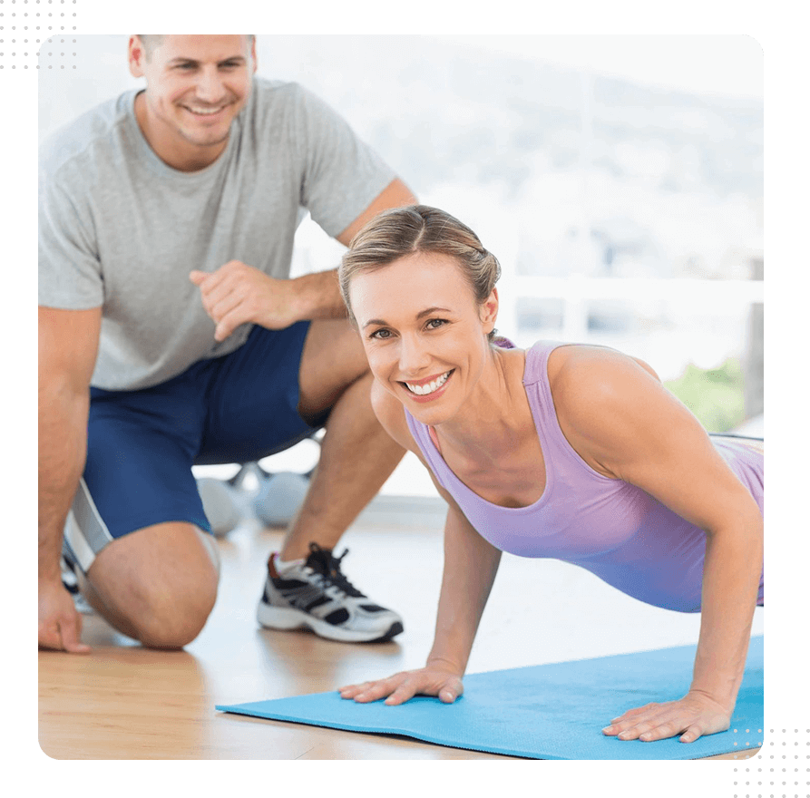 A man and woman are doing exercises on the floor.